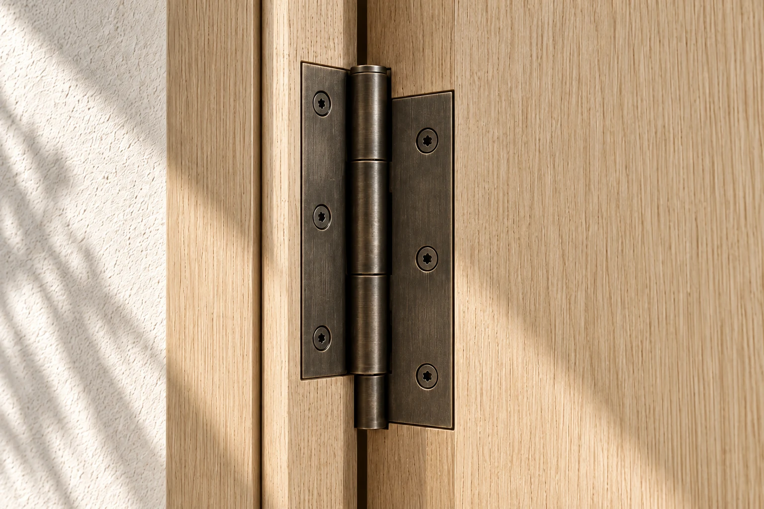 Bronze hinge fitted into oak